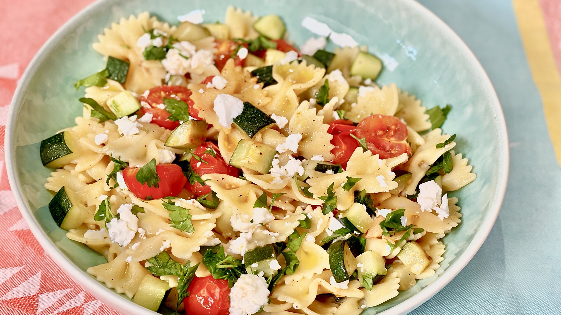 Farfalle pasta with greens, cherry tomatoes and feta