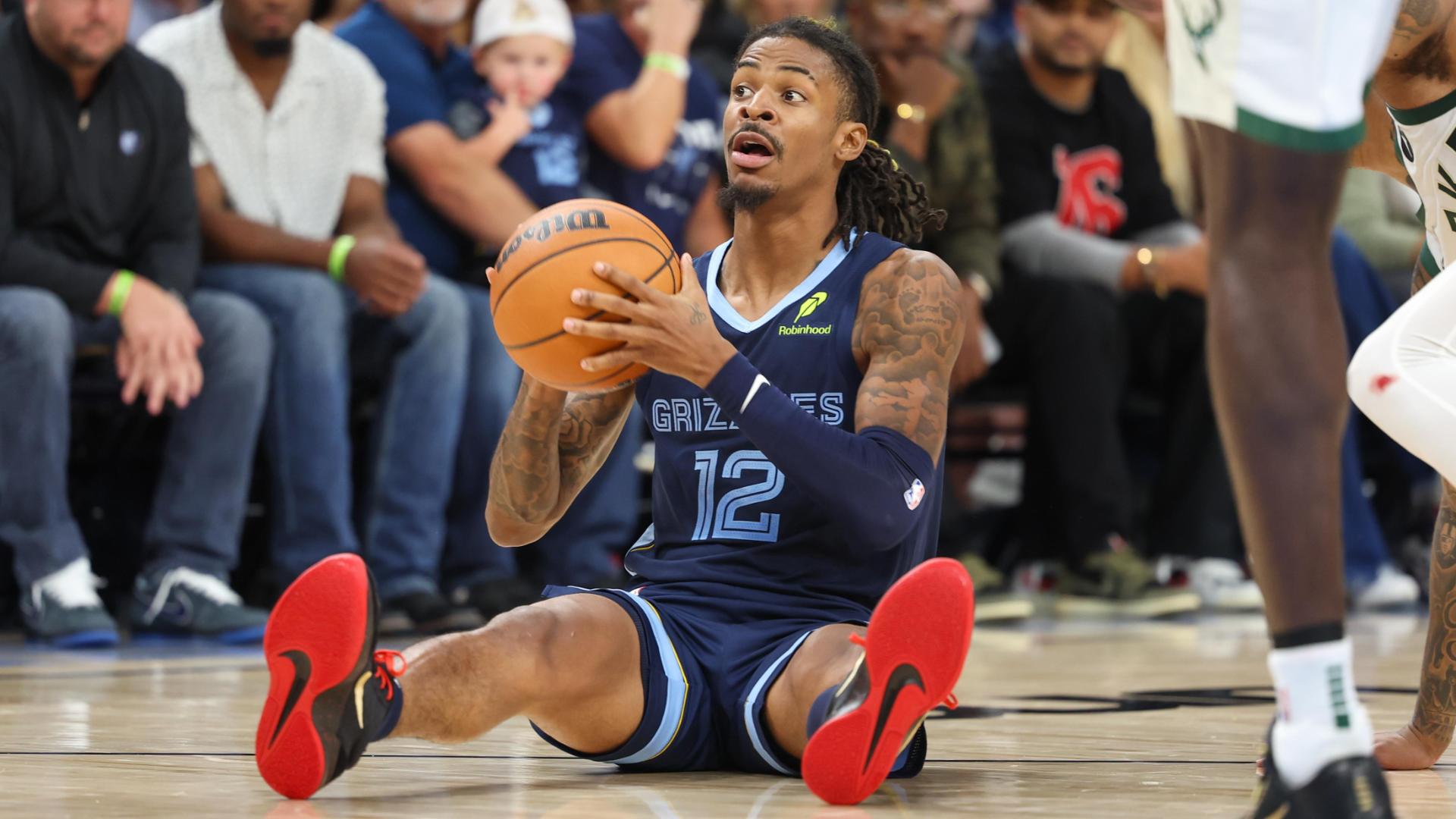 Must See Ja Morant throws up alleyoop while sitting down Video